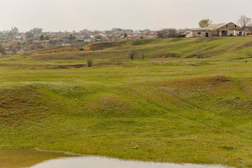 Obraz premium The outskirts of a small town in the Republic of Moldova. The terrain in southern Europe. Budzhak steppe, Spring pasture, artificial reservoir.