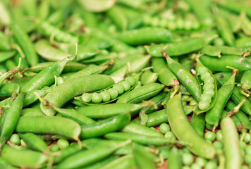 Green peas and pea pod on wood desk