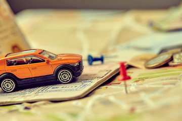 travel concept - small toy car on the map
