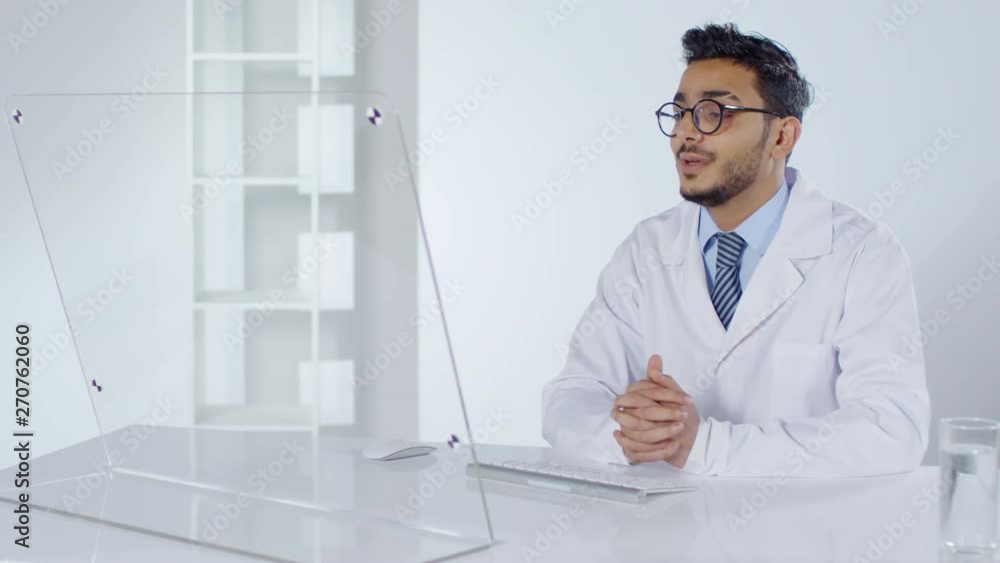 Aufkleber medium shot of arab male doctor in lab coat sitting at futuristic computer with transparent display 