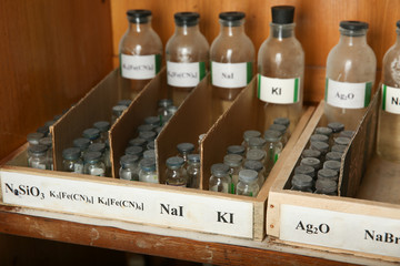 bottles with solutions of KI, NaI, Ag2O, on the shelf of the chemical cabinet. Sodium iodide, Silver oxide, are in the bottles 