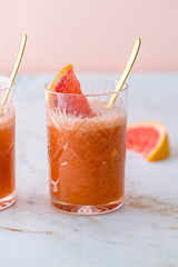 Grapefruit cocktail or mocktail on marble table top