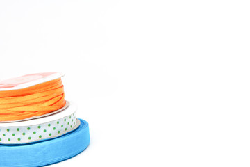bobbins with ribbon for packing flowers and gifts on white background with copy space