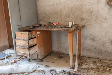 Desk in an empty textile factory office that is bankrupt and demolished