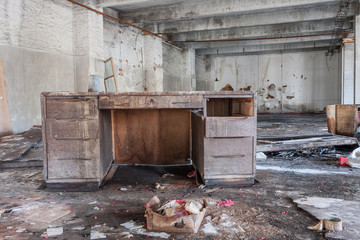 Table in hall of abandoned textile factory, that is bankrupt and demolished.
