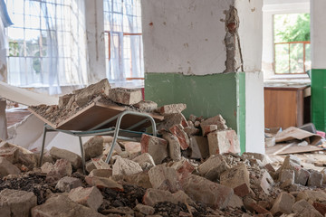 Broken school desk in abandoned textile factory, that is bankrupted and demolished