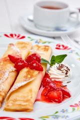 crepes with strawberry sauce and whipped cream