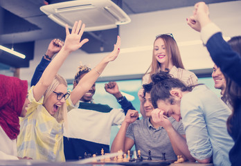 multiethnic group of business people playing chess