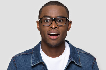Amazed african man wearing glasses looking at camera