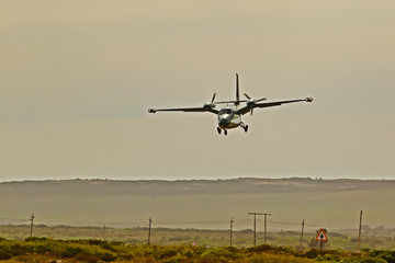 Fototapeta na wymiar Twin-engine pusher propeller aircraft landing