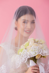 Beautiful asian bride portrait in pink studio