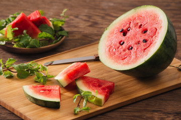 Sliced watermelon on the wood background