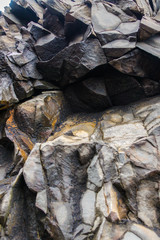 Grey basalt columns near Reynisdrangar beach, Iceland .