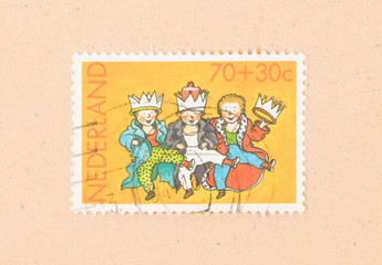 THE NETHERLANDS 1980: A stamp printed in the Netherlands shows three children with crowns, circa...