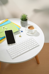 Top view office table desk.Workspace with mobile phone and office supplies on white background.