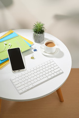 Fototapeta premium Top view office table desk.Workspace with mobile phone and office supplies on white background.