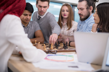 multiethnic group of business people playing chess