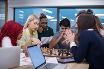 multiethnic group of business people playing chess