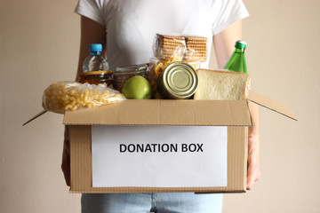 girl holding a box with donations