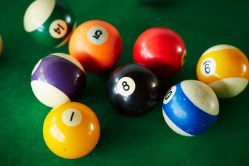 Billiards balls on green table 