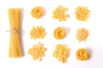 Different types of pasta on a white background top view.