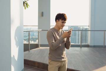 A man stading isolated and using phone
