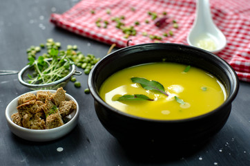 green pea cream soup healthy vegetarian organic food recipe with croutons, garlik and  greens. Homemade traditional meal.