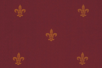 Texture of the golden crown pattern on a red velvet canvas. royal symbols closeup on luxury fabrics