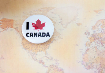 Canadian circle flag symbol with maple leaf.