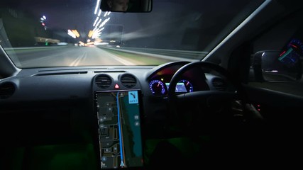 The man driving a car in the night city. Hyperlapse - Powered by Adobe