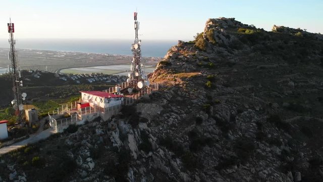 Aerial drone view of telecommunication antennas at sunset, in Segaria mountain, in Marina Alta, Alicante, Spain