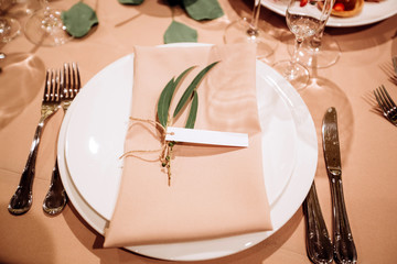 Table setting for a wedding ceremony at swimming pool. round table with white tablecloth