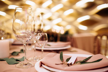 Table setting for a wedding ceremony at swimming pool. round table with white tablecloth