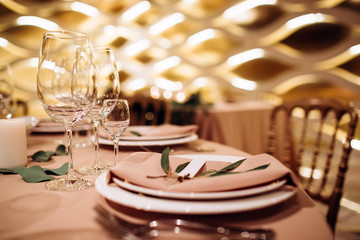 Table setting for a wedding ceremony at swimming pool. round table with white tablecloth
