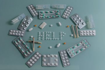 set of loose pills and complete tablets on green glass table