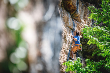 Man climbs rock.