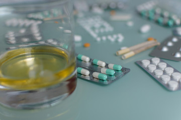set of loose pills and complete tablets on green glass table