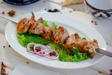 Fresh barbecue meat on white plate.