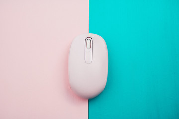 Pink computer mouse with a colorful background