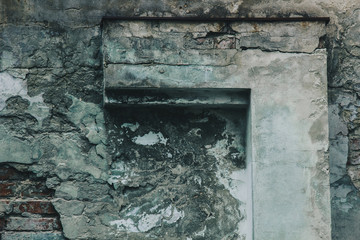 texture of old peeling gray wall covered with plaster closeup. time breaking background