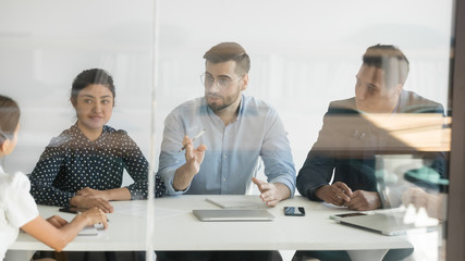 Multiethnic team talk discussing cooperation with business client