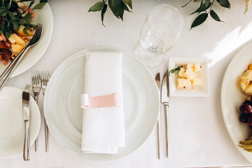 Table setting for a wedding ceremony at swimming pool. round table with white tablecloth