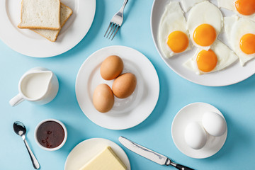 top view of served breakfast with two slices of bread on blue background