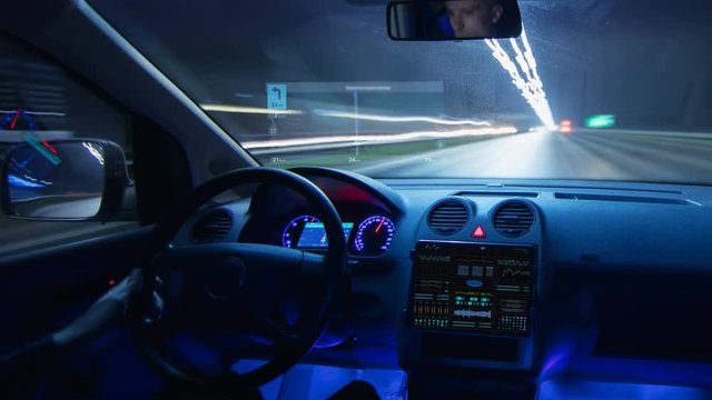 The man driving a car with a virtual navigator in a night city. Hyperlapse