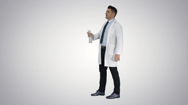 Male worker spraying pesticide on flying insects on gradient background.