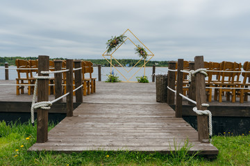 Obraz premium wedding ceremony on the lake shore wedding arch decor. Wedding concept