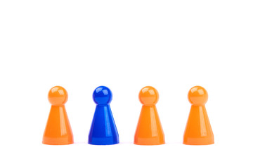 A series of orange game pieces and one different and exceptional blue figure as leader or boss,...