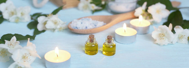 Aromatic oils, sea salt, candles and jasmine flowers. Spa ingredients for massage and relaxation.