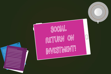 Conceptual hand writing showing Social Return On Investment. Business photo text Invest part of the earnings in donations Tablet Screen Cup Saucer and Filler Sheets on Color Background