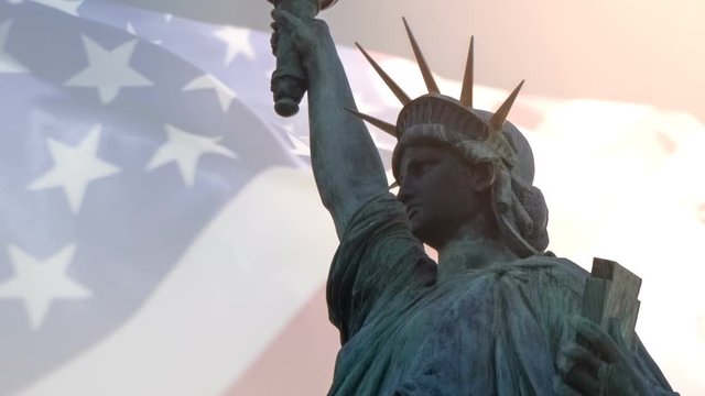 Double exposure with American flag waving and statue of liberty for Memorial Day or Independence Day.